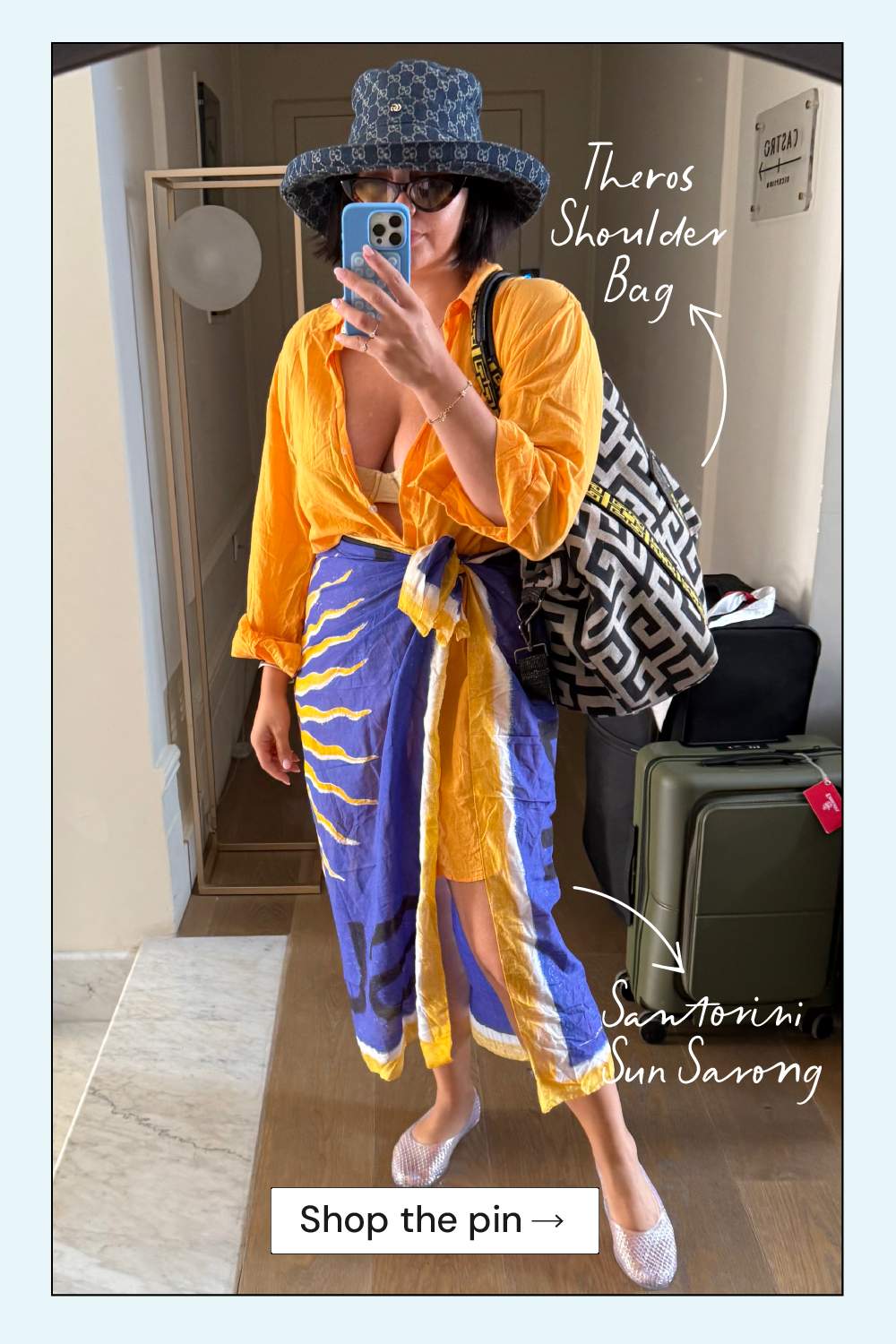 Person wearing a yellow outfit with blue accents, holding a patterned shoulder bag, standing in a room.
